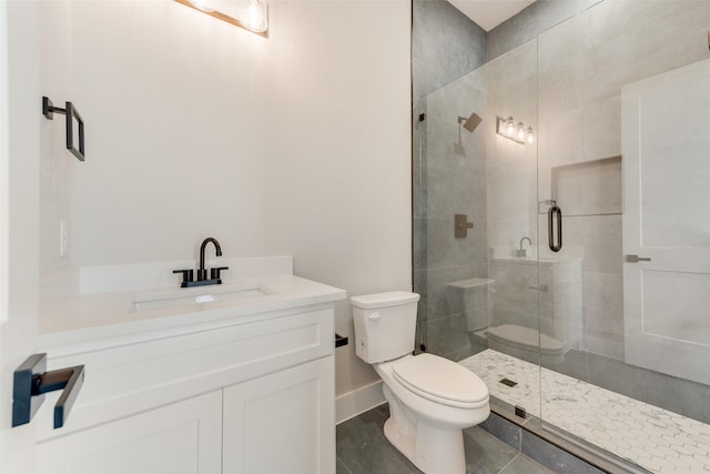 bathroom with vanity, a shower with shower door, and toilet