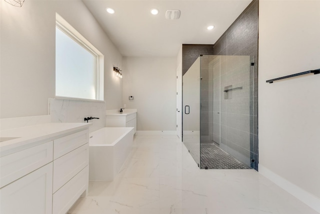 bathroom featuring vanity and separate shower and tub