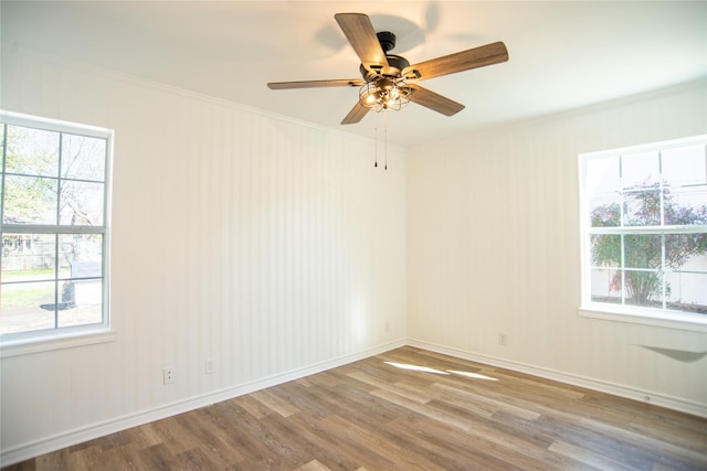 unfurnished room with hardwood / wood-style flooring and crown molding