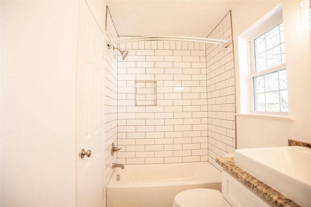 bathroom featuring toilet and tiled shower / bath combo