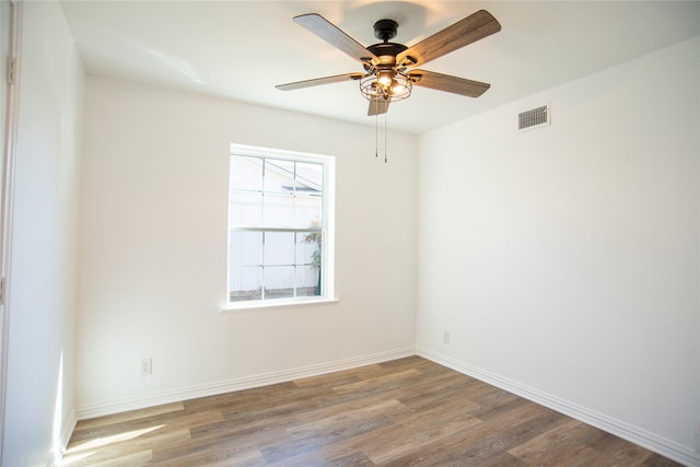 empty room with hardwood / wood-style floors and ceiling fan