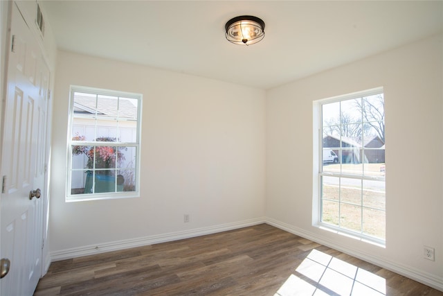 unfurnished room featuring dark wood-type flooring