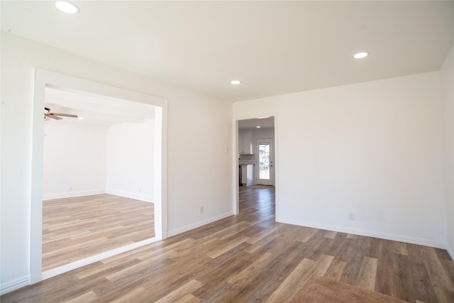 spare room with hardwood / wood-style floors and ceiling fan