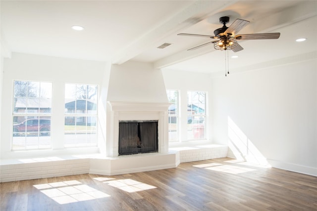 unfurnished living room with beam ceiling, light hardwood / wood-style flooring, and ceiling fan