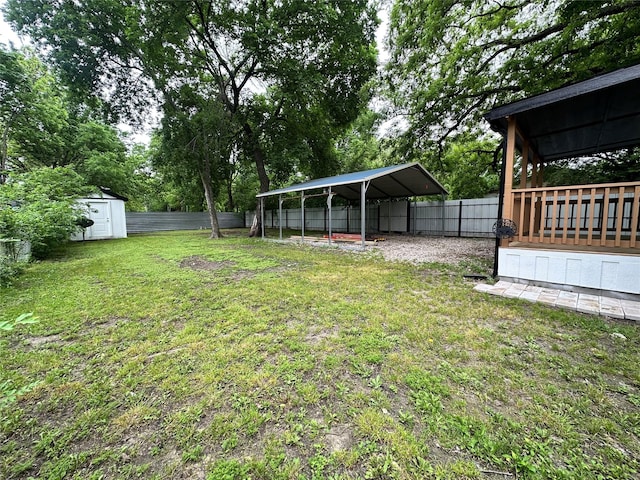 view of yard with a shed and a carport