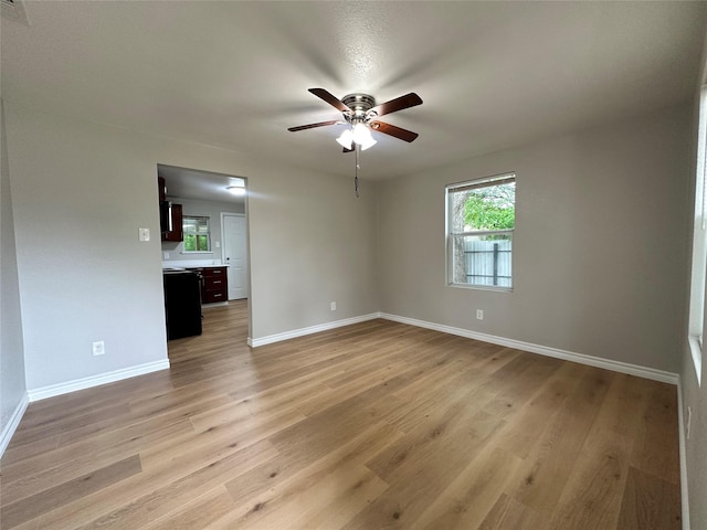 unfurnished room featuring ceiling fan and light wood-type flooring