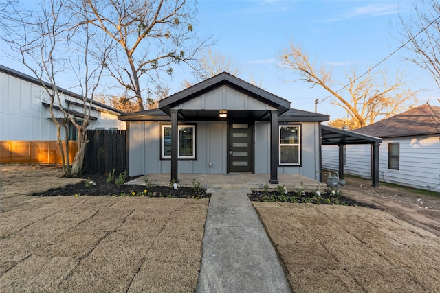 view of front of home featuring a carport and covered porch