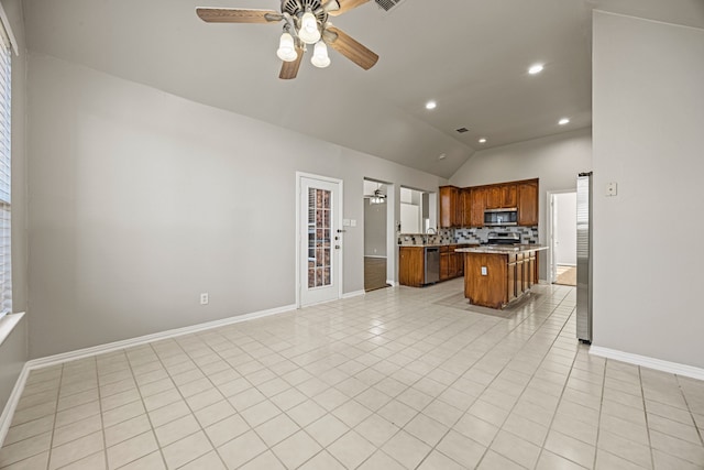 kitchen featuring tasteful backsplash, light tile patterned flooring, a center island, and appliances with stainless steel finishes