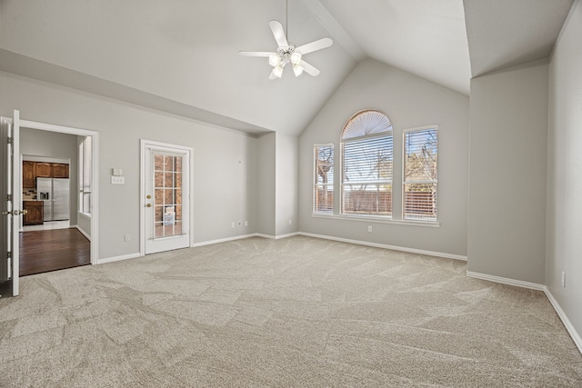 carpeted spare room with lofted ceiling and ceiling fan