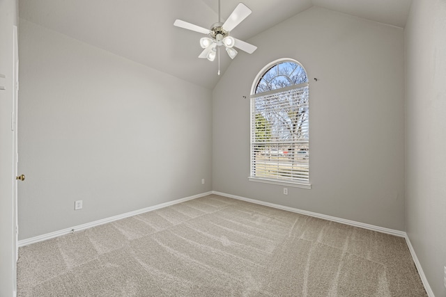 spare room featuring lofted ceiling, light colored carpet, and ceiling fan