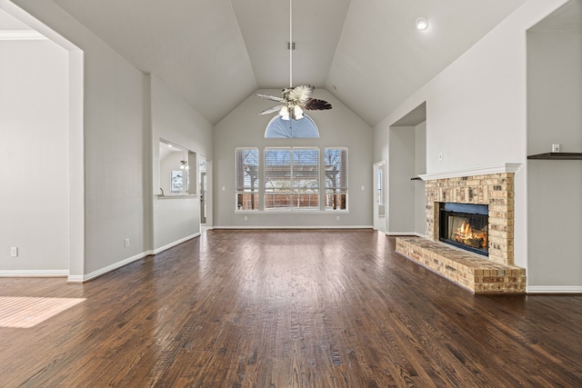 unfurnished living room featuring dark hardwood / wood-style flooring, a brick fireplace, high vaulted ceiling, and ceiling fan