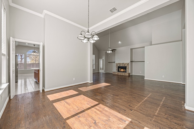 unfurnished living room featuring dark hardwood / wood-style floors, high vaulted ceiling, a fireplace, and ceiling fan with notable chandelier