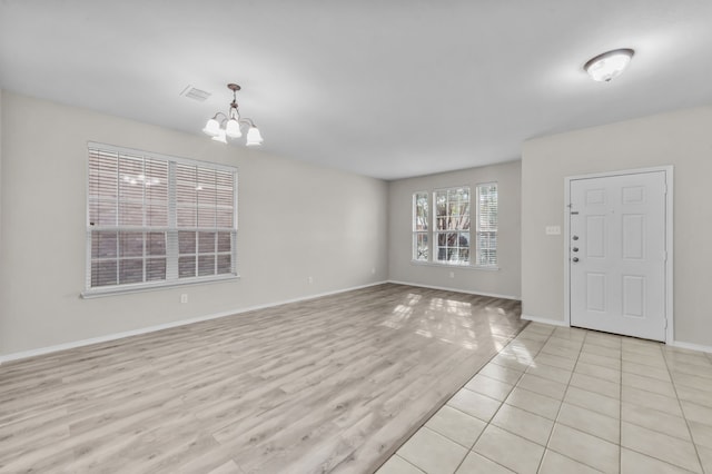 interior space featuring a chandelier and light hardwood / wood-style flooring