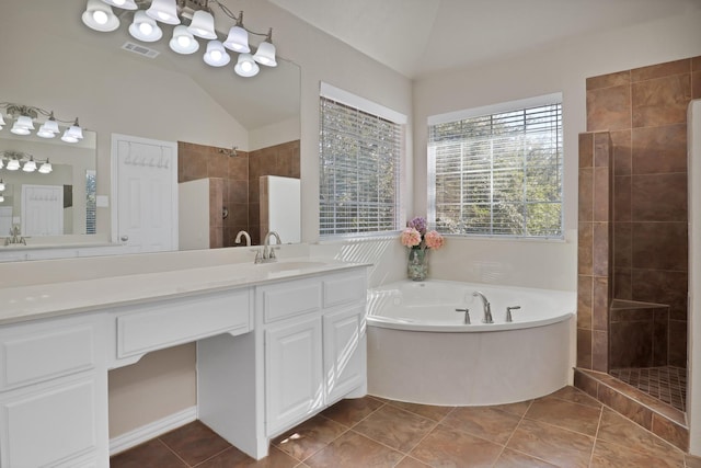 bathroom with tile patterned flooring, plus walk in shower, lofted ceiling, and vanity