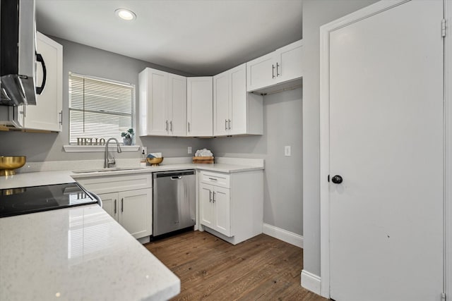 kitchen with dark hardwood / wood-style floors, white cabinetry, sink, stove, and stainless steel dishwasher