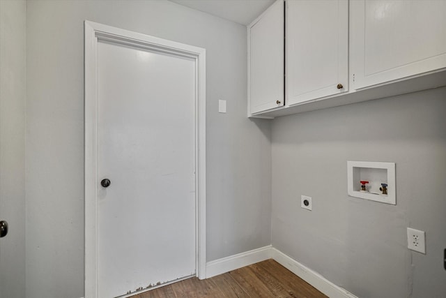 clothes washing area with cabinets, electric dryer hookup, hookup for a washing machine, and dark hardwood / wood-style flooring