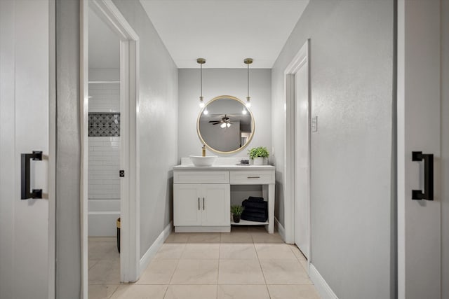 bathroom featuring vanity and tiled shower / bath