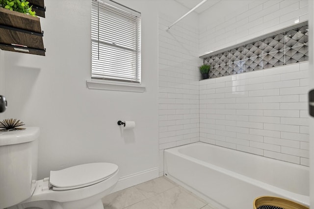 bathroom featuring tiled shower / bath and toilet