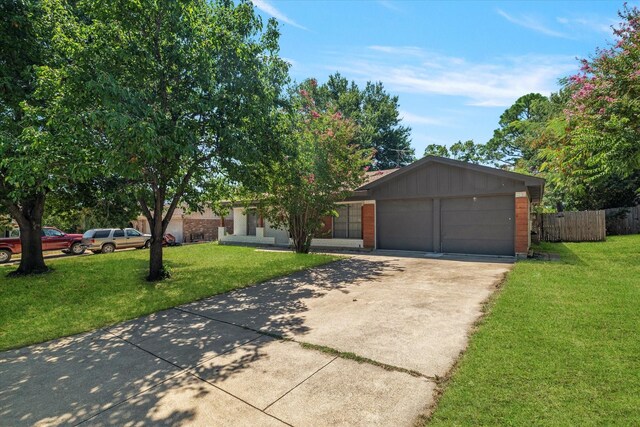 single story home with a garage and a front lawn