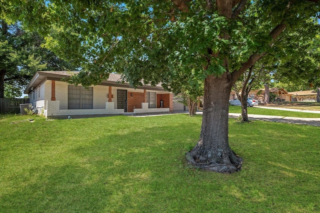 view of front facade with central AC and a front lawn