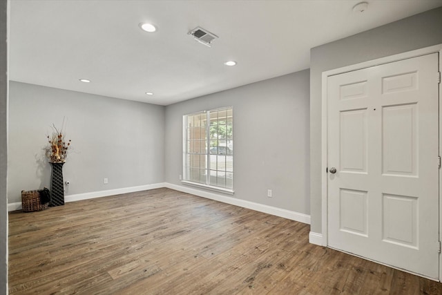 unfurnished room with hardwood / wood-style floors