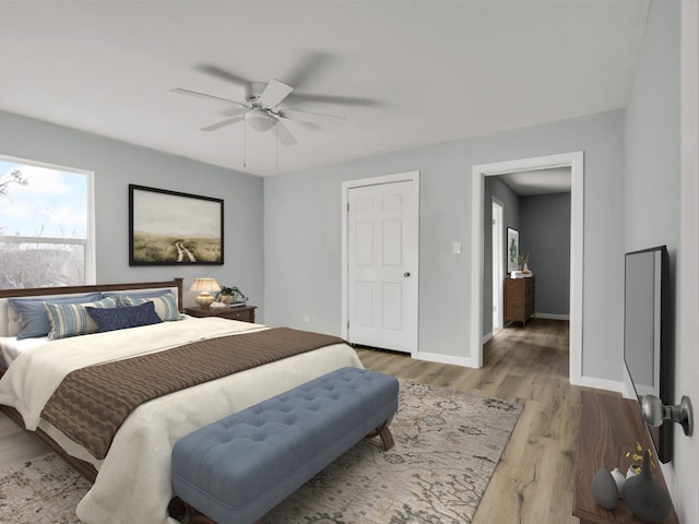 bedroom with wood-type flooring and ceiling fan