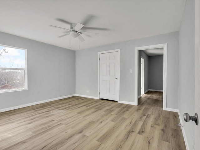 empty room featuring ceiling fan and light wood-type flooring