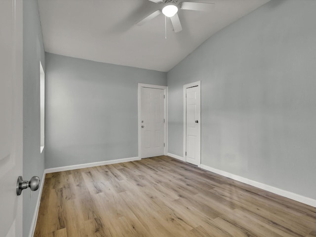 empty room featuring vaulted ceiling, ceiling fan, and light hardwood / wood-style floors