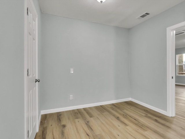 unfurnished room with light hardwood / wood-style flooring