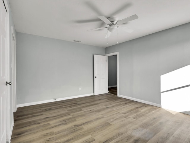 unfurnished bedroom with wood-type flooring, a closet, and ceiling fan