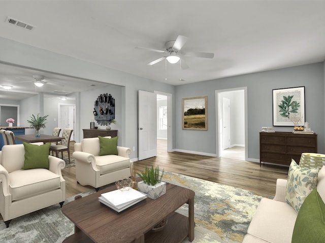 living room featuring wood-type flooring and ceiling fan