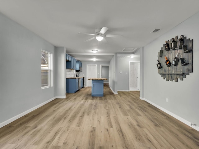 unfurnished living room featuring ceiling fan and wood-type flooring