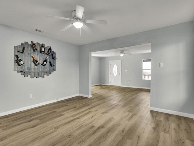 spare room with ceiling fan and light wood-type flooring