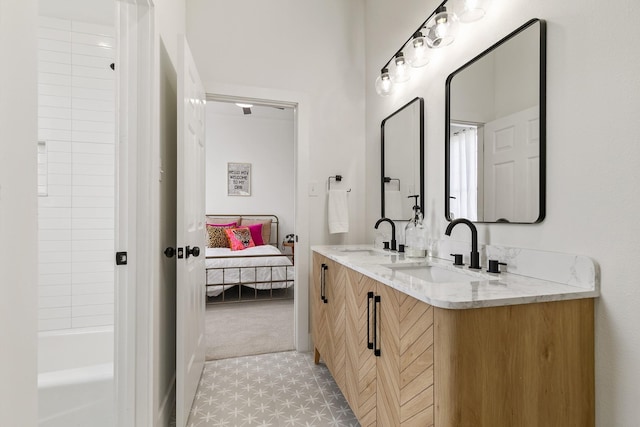 ensuite bathroom featuring a sink, tub / shower combination, double vanity, and ensuite bath