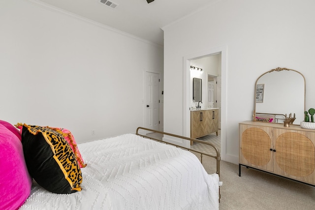 bedroom with ensuite bathroom, carpet flooring, crown molding, and visible vents