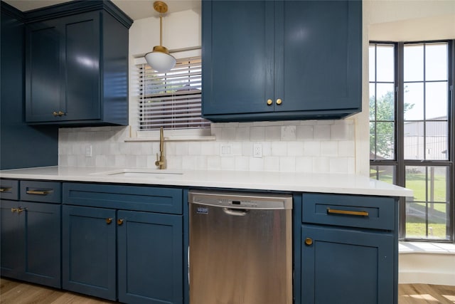 kitchen with sink, backsplash, stainless steel dishwasher, and blue cabinetry