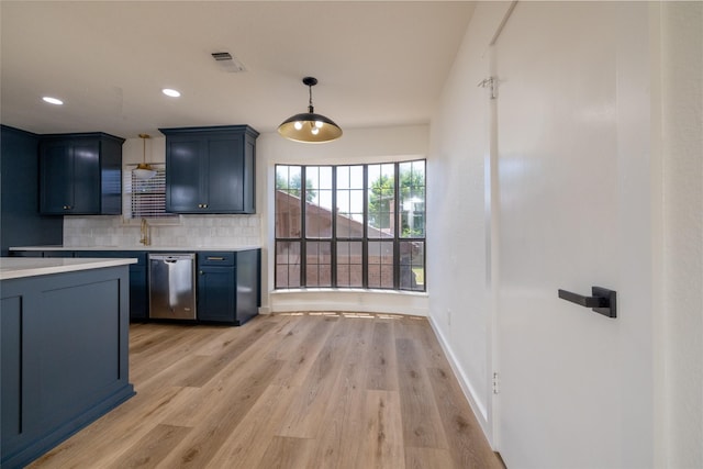 kitchen featuring blue cabinets, dishwasher, pendant lighting, light hardwood / wood-style floors, and backsplash