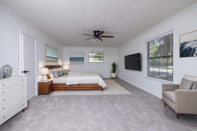 carpeted bedroom featuring crown molding and ceiling fan