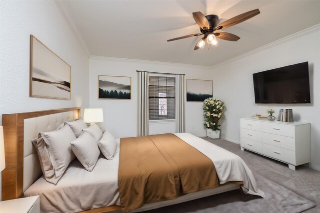 bedroom with crown molding, carpet floors, and ceiling fan