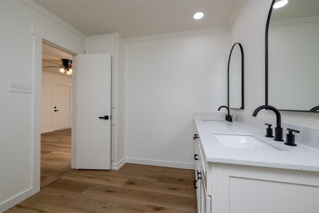 bathroom with ornamental molding, hardwood / wood-style floors, and vanity