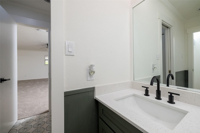 bathroom featuring vanity, ornamental molding, and ceiling fan