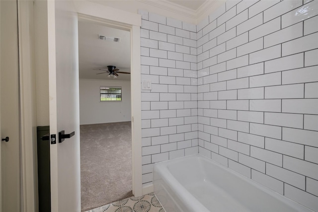 bathroom with tiled shower / bath, crown molding, and ceiling fan