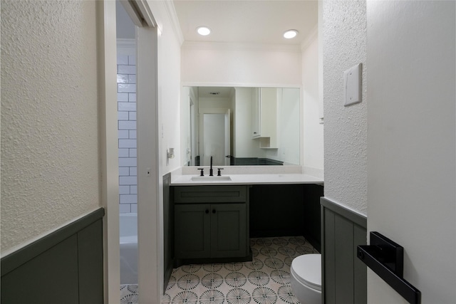 bathroom featuring ornamental molding, toilet, and vanity