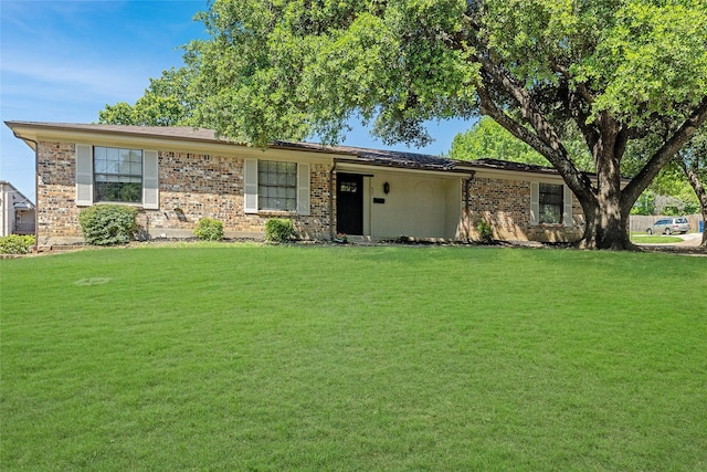 single story home with a front lawn and brick siding