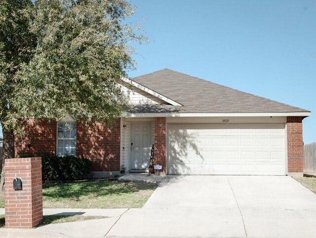 ranch-style home with a garage, concrete driveway, brick siding, and roof with shingles