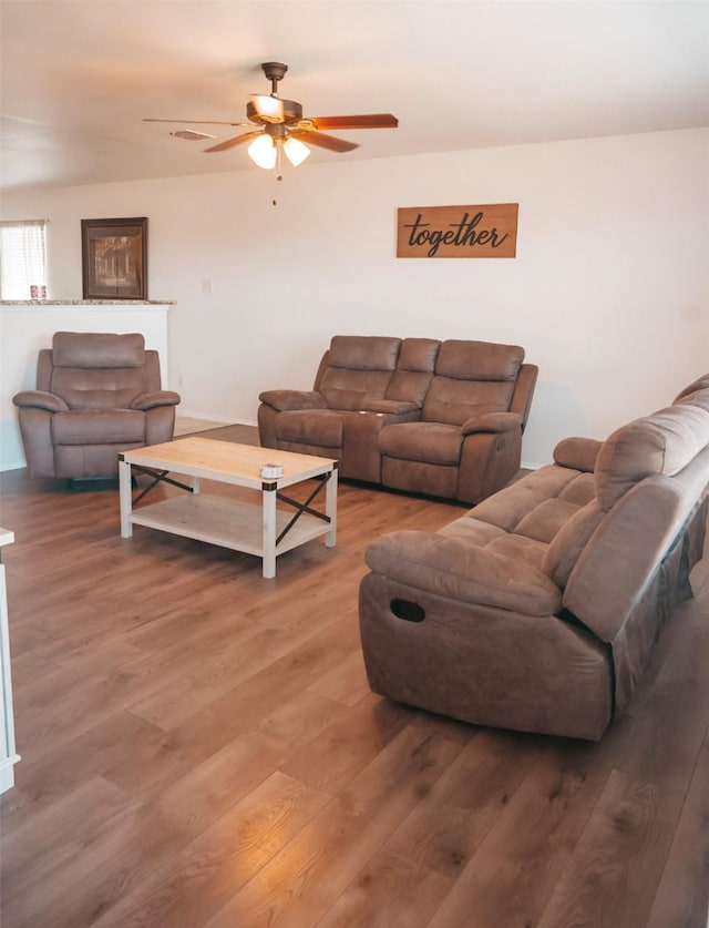 living room featuring ceiling fan and hardwood / wood-style floors