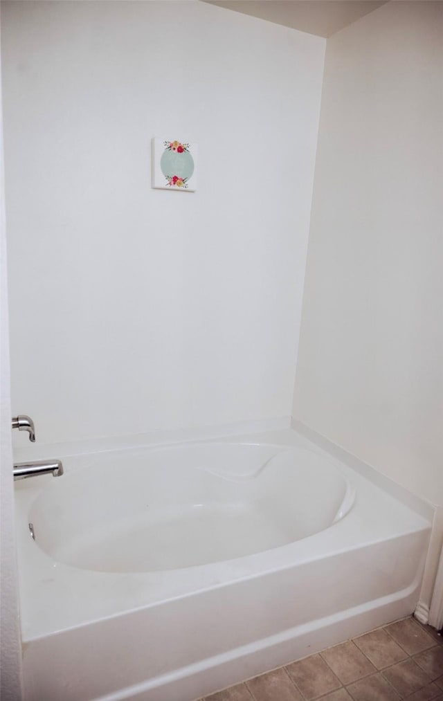 bathroom with tile patterned flooring and a bathing tub