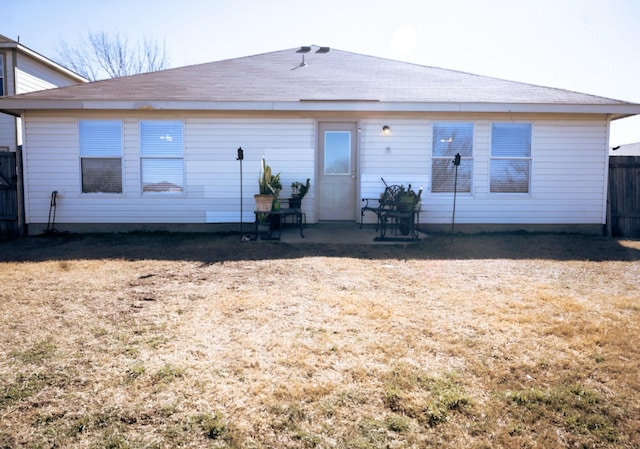 back of house featuring a patio and a yard