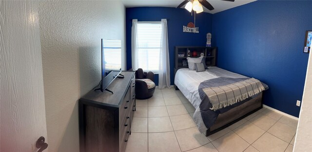 laundry room with light tile patterned flooring, cabinets, and washer and clothes dryer