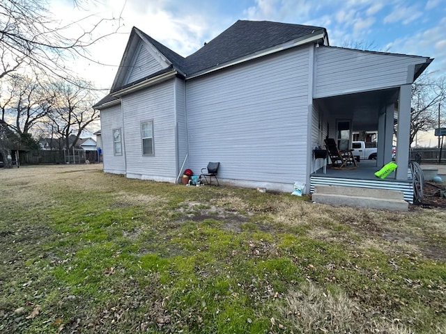 view of side of home with a lawn